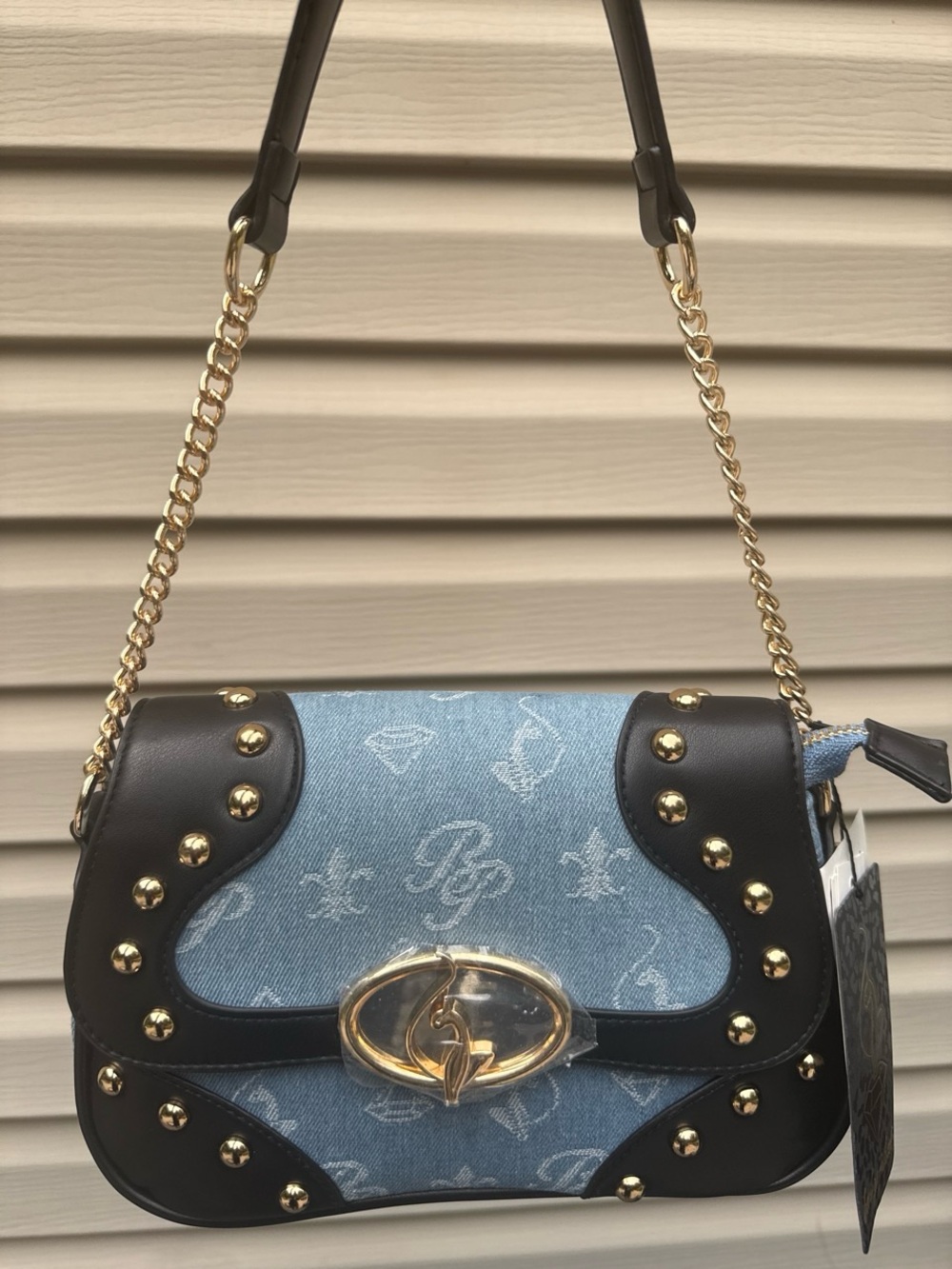 Baby Phat blue denim with black faux leather trim and gold and black trim